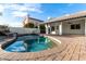 Beautiful pool with red brick border in a lush backyard setting at 6809 E Gelding Dr, Scottsdale, AZ 85254