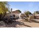 The backyard has multiple seating areas with a fireplace and outdoor kitchen at 8171 W Beaubien Dr, Peoria, AZ 85382