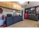 Garage with built-in storage cabinets, work space, and a dart board at 8171 W Beaubien Dr, Peoria, AZ 85382