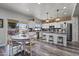 Bright, spacious kitchen featuring stainless steel appliances, white cabinets, and a breakfast bar with pendant lighting at 8171 W Beaubien Dr, Peoria, AZ 85382