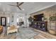 Stylish living room with a stone wall, ceiling fan, and a spacious layout perfect for entertaining guests at 8171 W Beaubien Dr, Peoria, AZ 85382