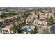 Community aerial view of a pool surrounded by condominiums, trees, and manicured lawns at 9705 E Mountain View Rd # 1050, Scottsdale, AZ 85258