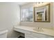 Bathroom vanity with an ornate mirror and a window overlooking green foliage at 9705 E Mountain View Rd # 1050, Scottsdale, AZ 85258