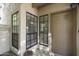 Welcoming front entry with a stylish front door, well-placed windows, and a decorative potted plant at 9705 E Mountain View Rd # 1050, Scottsdale, AZ 85258