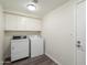 Laundry room featuring a washer, dryer, and overhead cabinets for storage at 9705 E Mountain View Rd # 1050, Scottsdale, AZ 85258