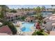 Aerial view of community pool area with lounging chairs, cabana, and lush landscaping at 9705 E Mountain View Rd # 1050, Scottsdale, AZ 85258