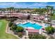 Aerial view of the community pool, amenities, and meticulously maintained landscaping and lawn areas at 9725 E Navajo Pl, Sun Lakes, AZ 85248