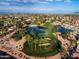 Scenic aerial view of lush golf course, serene ponds, and surrounding community homes at 9725 E Navajo Pl, Sun Lakes, AZ 85248