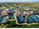 Aerial view of community amenities, including pools, tennis courts, and clubhouse amidst golf course at 9725 E Navajo Pl, Sun Lakes, AZ 85248