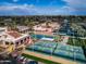 Aerial view showcasing the community's pool, tennis, and pickleball courts, surrounded by well-maintained landscaping at 9725 E Navajo Pl, Sun Lakes, AZ 85248