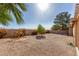 Spacious backyard showcasing desert landscaping with various trees and bushes creating a serene and low-maintenance outdoor space at 9725 E Navajo Pl, Sun Lakes, AZ 85248