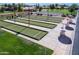 Overhead view of a well-maintained bocce ball court with landscaping and tables for spectators at 9725 E Navajo Pl, Sun Lakes, AZ 85248