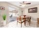 Sunny dining area with a view of the backyard, a ceiling fan, and easy patio access at 9725 E Navajo Pl, Sun Lakes, AZ 85248