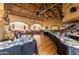 Spacious dining room featuring buffet line, tables with red chairs, and vaulted wood beam ceiling at 9725 E Navajo Pl, Sun Lakes, AZ 85248