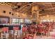 A spacious dining room with tables, chairs, fireplace and ample space for residents to enjoy meals together at 9725 E Navajo Pl, Sun Lakes, AZ 85248