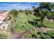 A winding golf cart path meanders through a lush green golf course lined with mature palm trees at 9725 E Navajo Pl, Sun Lakes, AZ 85248