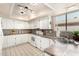 Well-lit kitchen featuring white appliances, mosaic backsplash, and tiled countertops at 9725 E Navajo Pl, Sun Lakes, AZ 85248