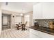 Bright kitchen area with a cozy desk nook, white cabinets, and tiled flooring at 9725 E Navajo Pl, Sun Lakes, AZ 85248