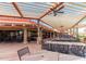 Inviting outdoor patio with ceiling fans, tables and chairs with view of the golf course at 9725 E Navajo Pl, Sun Lakes, AZ 85248