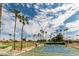 Outdoor tennis court with lush landscaping and nearby golf course at 9725 E Navajo Pl, Sun Lakes, AZ 85248