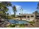 Lush backyard oasis featuring a pool, rock features, and a serene seating area at 10685 E Cinnabar Ave, Scottsdale, AZ 85258