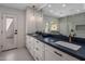 Elegant bathroom with dual sinks, stone countertop, and modern fixtures at 10685 E Cinnabar Ave, Scottsdale, AZ 85258