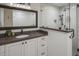 Stylish bathroom with a glass-enclosed shower, white vanity, and dark countertops at 10685 E Cinnabar Ave, Scottsdale, AZ 85258