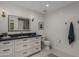 Modern bathroom featuring a white vanity with a gray countertop, framed mirror, and updated fixtures at 10685 E Cinnabar Ave, Scottsdale, AZ 85258