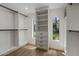 Walk-in closet with built-in shelving and natural light from a window at 10685 E Cinnabar Ave, Scottsdale, AZ 85258