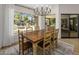 Cozy dining room featuring a rustic wooden table and chairs with backyard views at 10685 E Cinnabar Ave, Scottsdale, AZ 85258