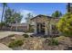 Attractive home showcasing desert landscaping, a covered entrance, and a three-car garage at 10685 E Cinnabar Ave, Scottsdale, AZ 85258