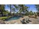 Landscaped backyard features a pool with rock accents, waterfall and ample seating at 10685 E Cinnabar Ave, Scottsdale, AZ 85258