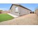 Artificial turf backyard with gravel and home exterior at 11004 N 154Th Ln, Surprise, AZ 85379