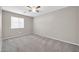 Well-lit bedroom with ceiling fan and carpet at 11004 N 154Th Ln, Surprise, AZ 85379