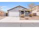 Single-story house with gray exterior, attached garage, and neatly landscaped front yard at 11004 N 154Th Ln, Surprise, AZ 85379