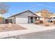 Single-story house with gray exterior, attached garage, and well-maintained landscaping at 11004 N 154Th Ln, Surprise, AZ 85379