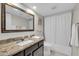 This cozy bathroom features a granite vanity top, a shower-tub combo, and tile flooring at 11129 N 109Th St, Scottsdale, AZ 85259