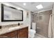 Modern bathroom with granite countertop, glass-enclosed shower, and ample natural light at 11129 N 109Th St, Scottsdale, AZ 85259