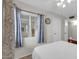 Bedroom featuring a white comforter, neutral paint, and blue curtains at 11129 N 109Th St, Scottsdale, AZ 85259