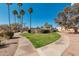 The community features lush green landscaping with walking paths and mature palm trees at 11129 N 109Th St, Scottsdale, AZ 85259