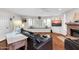 Bright living room with hardwood floors, bay window, fireplace, and a comfortable leather sofa at 11129 N 109Th St, Scottsdale, AZ 85259