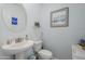 Clean and updated bathroom with pedestal sink and framed art at 13184 N 144Th Ln, Surprise, AZ 85379