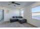 Cozy bedroom with gray sectional sofa and large windows at 13184 N 144Th Ln, Surprise, AZ 85379