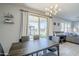 Dining area with dark wood table and access to the backyard patio at 13184 N 144Th Ln, Surprise, AZ 85379