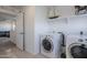 Convenient laundry room with washer, dryer, and extra shelving at 13184 N 144Th Ln, Surprise, AZ 85379