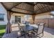 Relaxing covered patio with table and chairs, perfect for outdoor dining at 13184 N 144Th Ln, Surprise, AZ 85379