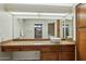 Bathroom vanity with granite countertop, modern sink, and wood cabinets at 13917 W Pavillion Dr, Sun City West, AZ 85375