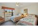 Bright bedroom with two twin beds and large window at 13917 W Pavillion Dr, Sun City West, AZ 85375