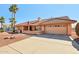 Single-story home with tile roof, desert landscaping, and a two-car garage at 13917 W Pavillion Dr, Sun City West, AZ 85375