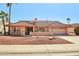 Single-story home with tile roof, desert landscaping, and a two-car garage at 13917 W Pavillion Dr, Sun City West, AZ 85375